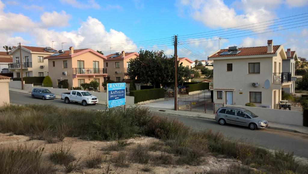 a street with cars parked on the side of the road at Kapsalia Holiday Villas in Pissouri