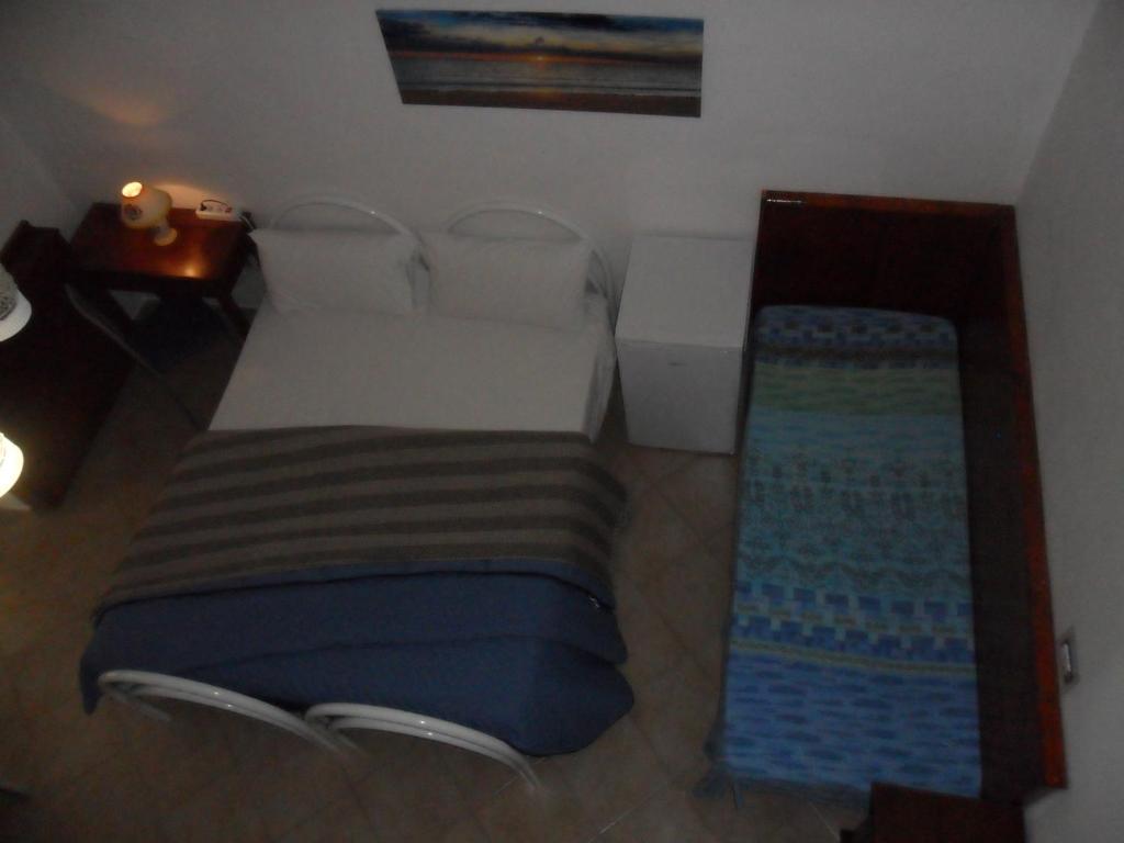 A bed or beds in a room at La Stanza Alternativa