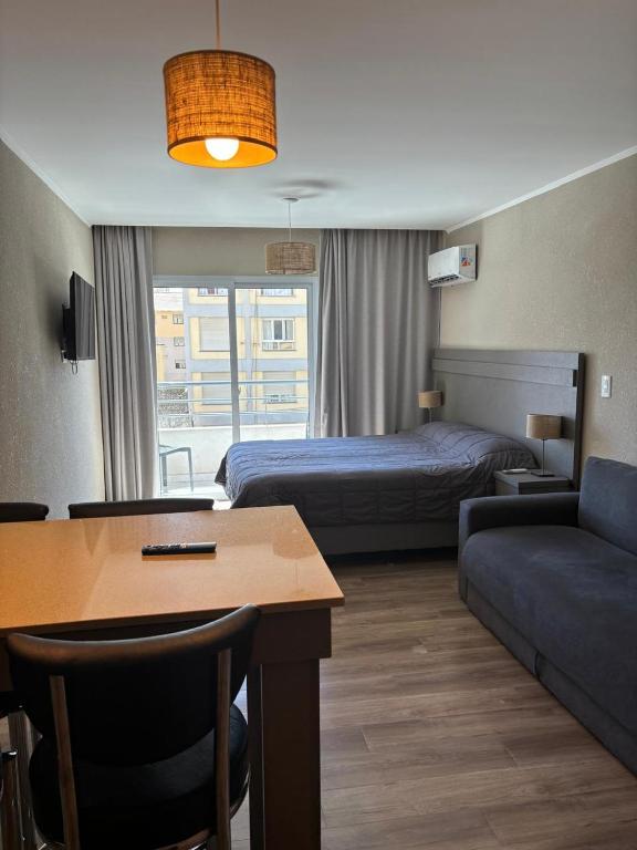a hotel room with a bed and a couch at Departamento Casa de playa in Necochea