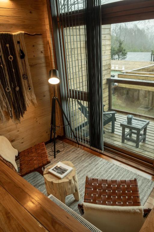 a living room with a couch and a table and a window at NI-NEWEN Hotel & Lodge in Pucón