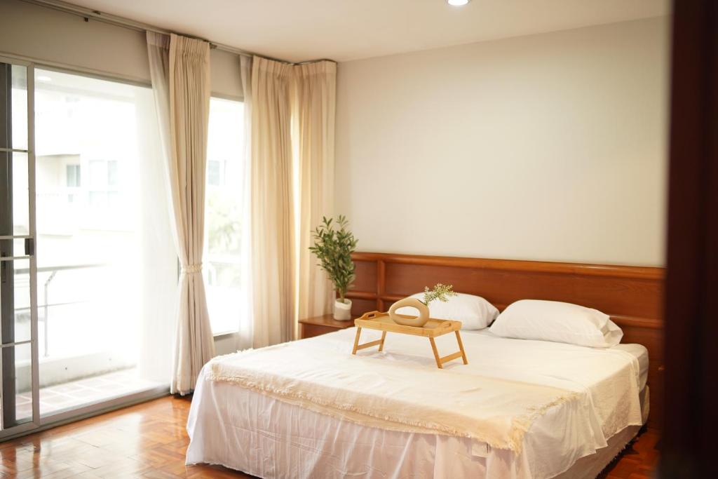 a bedroom with a bed with a table on it at Ma Peng Seng Apartment in Bangkok