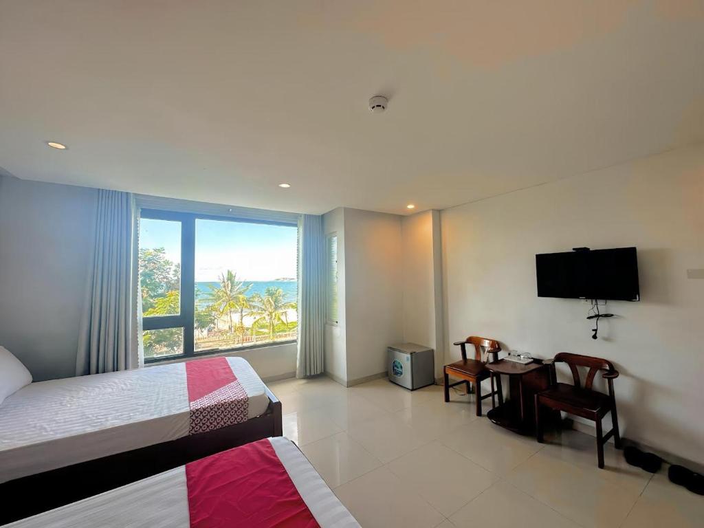 Postel nebo postele na pokoji v ubytování Huy Hoàng Hotel Đà Nẵng