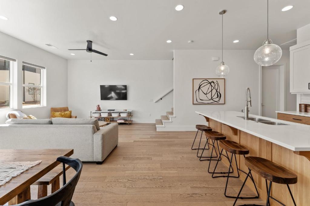 a kitchen and living room with a couch and a bar at Villa #15 at Bloomington Country Club Dog-Friendly townhouse in St. George
