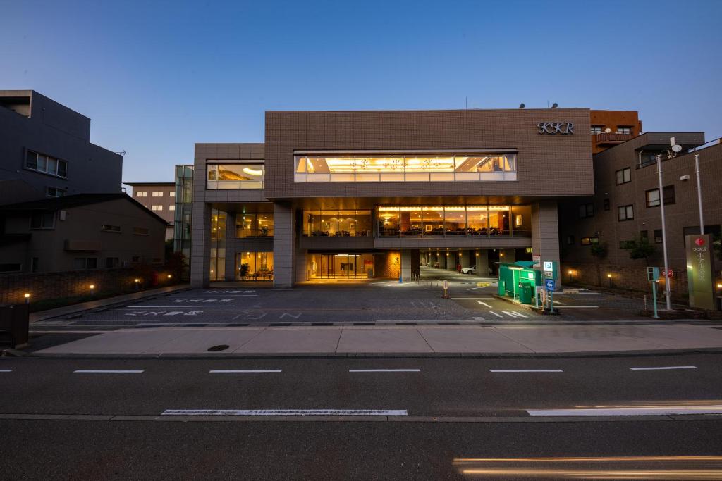 an empty parking lot in front of a building at KKR Hotel Kanazawa in Kanazawa