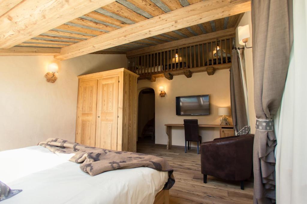 Postel nebo postele na pokoji v ubytování Hotel Les Montagnards