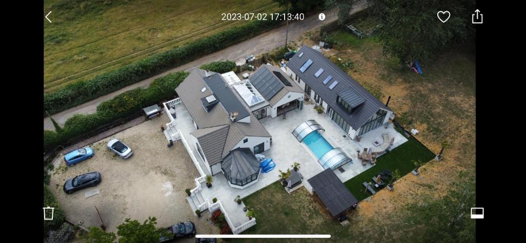 an overhead view of a large house with a pool at Green Acres House in Horspath