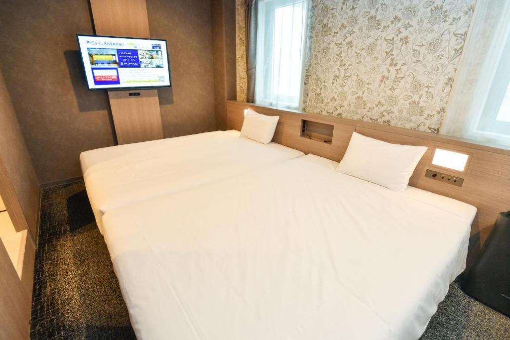 Postel nebo postele na pokoji v ubytování Sanco Inn Nagoya - Shinkansenguchi