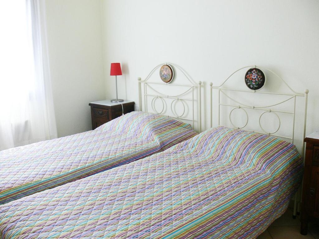 a bedroom with a bed with a striped comforter at Alkyon Villas in Syvota