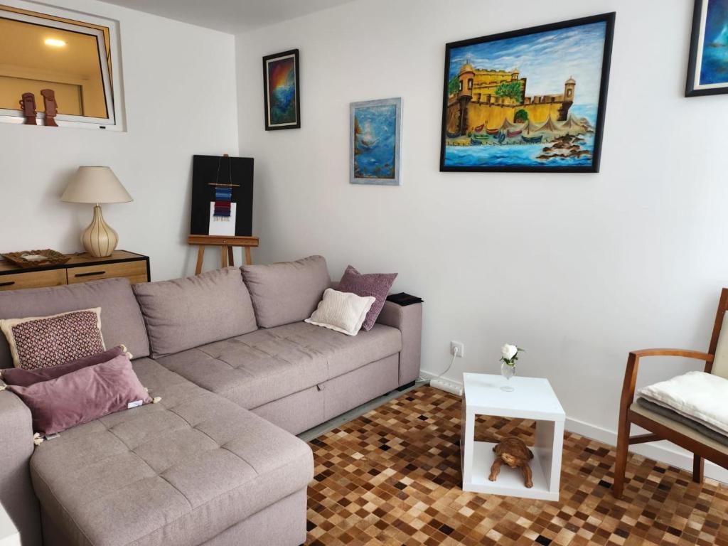 a living room with a couch and a table at Santa Beatriz Apartment in Machico
