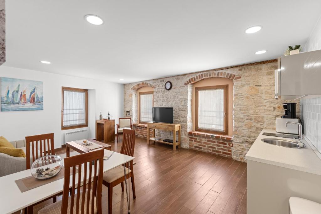 a kitchen and living room with a table and chairs at NEW!!!Apartment Old Town Square in Poreč