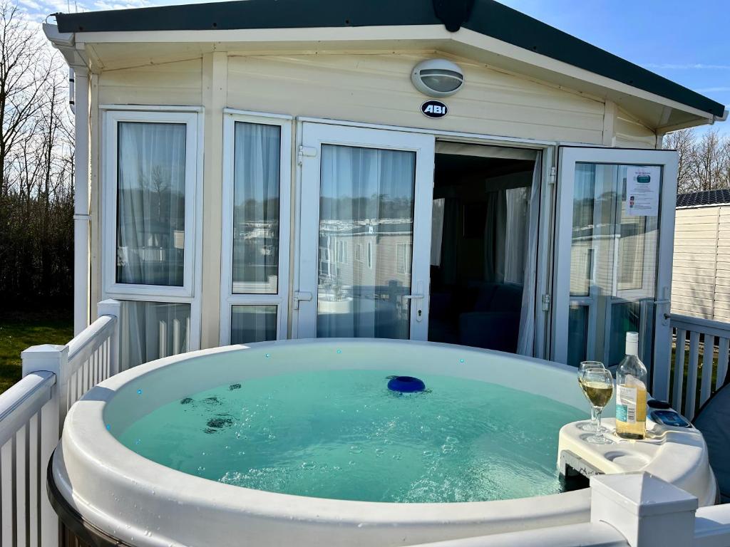 a hot tub in a backyard with a house at Holiday Home with Private Hot Tub in Bembridge