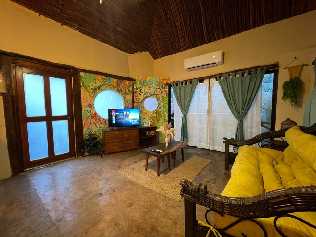 a bedroom with a bed and a tv in a room at Treehouse Loft in Prime Location in Playa del Carmen