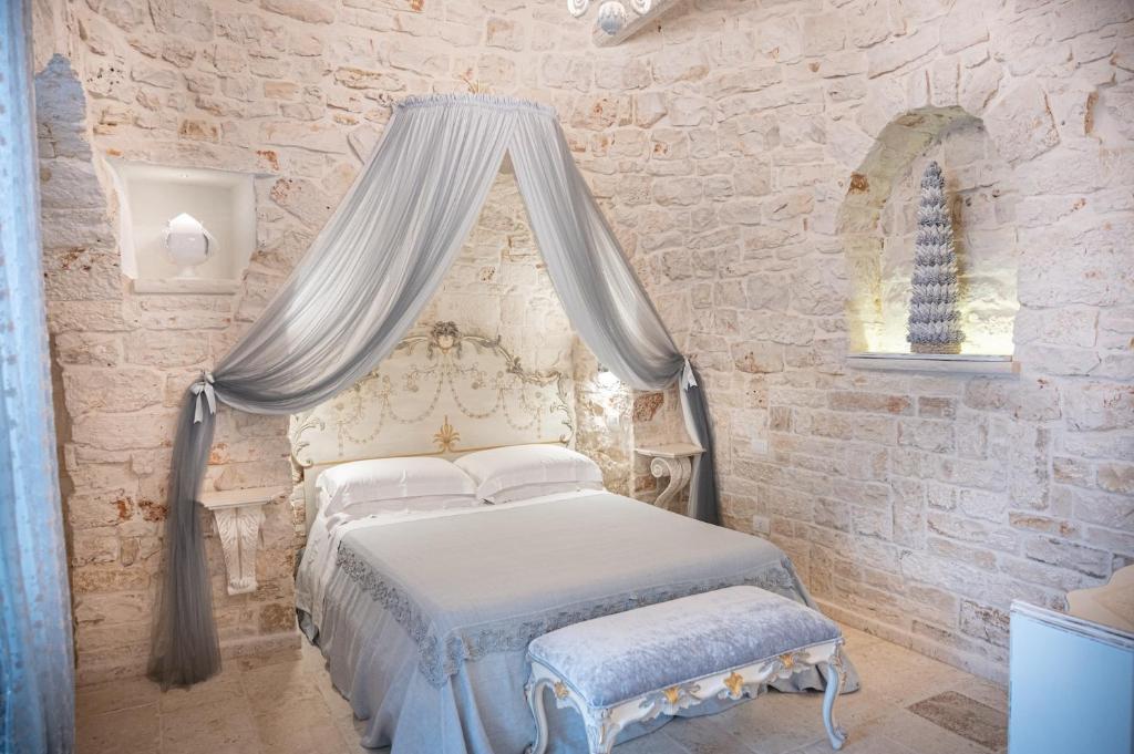 Postel nebo postele na pokoji v ubytování Romantic Trulli