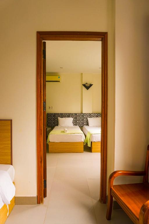 Postel nebo postele na pokoji v ubytování Paradise Hotel Hoi An