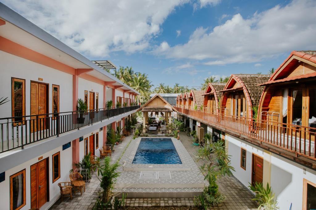 a view of the courtyard of a house with a swimming pool at Garuda Dive & Accomodation Nusa Penida in Nusa Penida