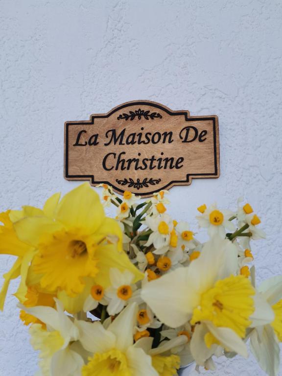 a sign that says a mission de christine above flowers at La Maison de Christine -Adults Only in Chrysi Ammoudia