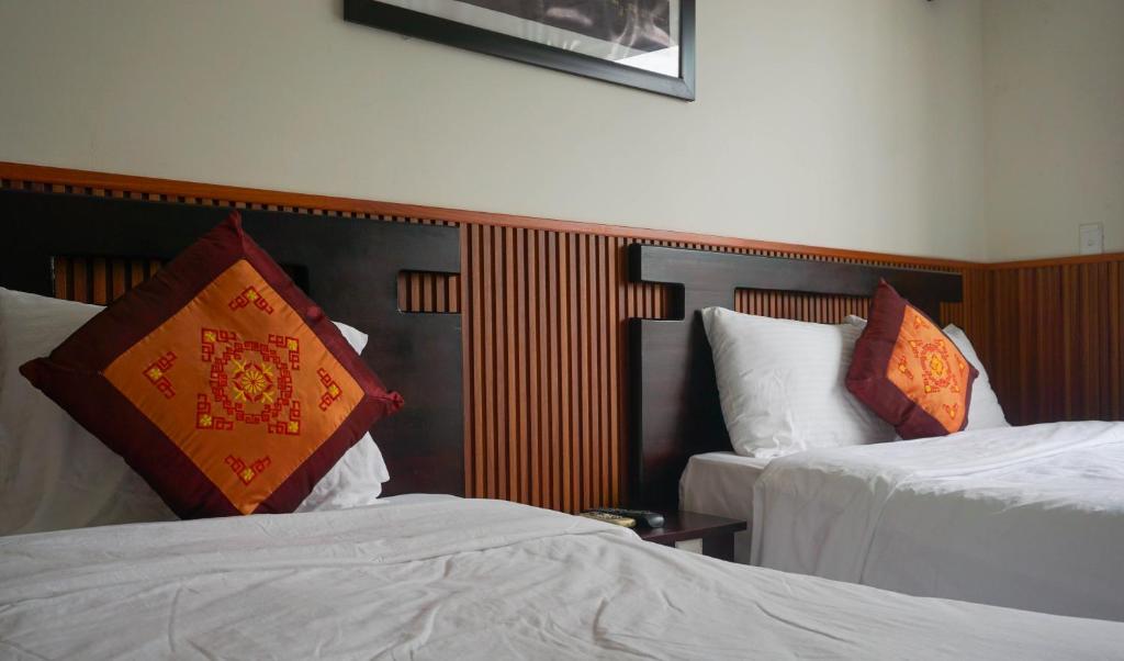 Postel nebo postele na pokoji v ubytování Paradise Hotel Hoi An