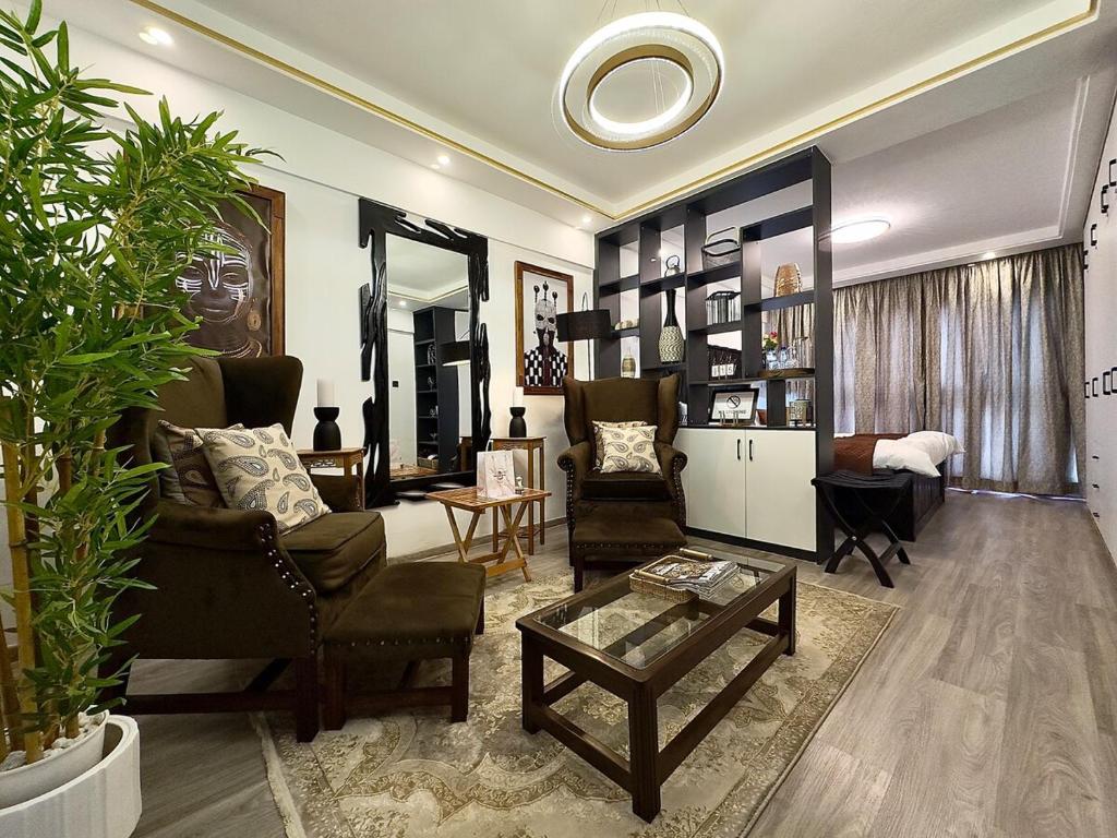 a living room with two chairs and a table at The Ikhaba Loft in Nairobi
