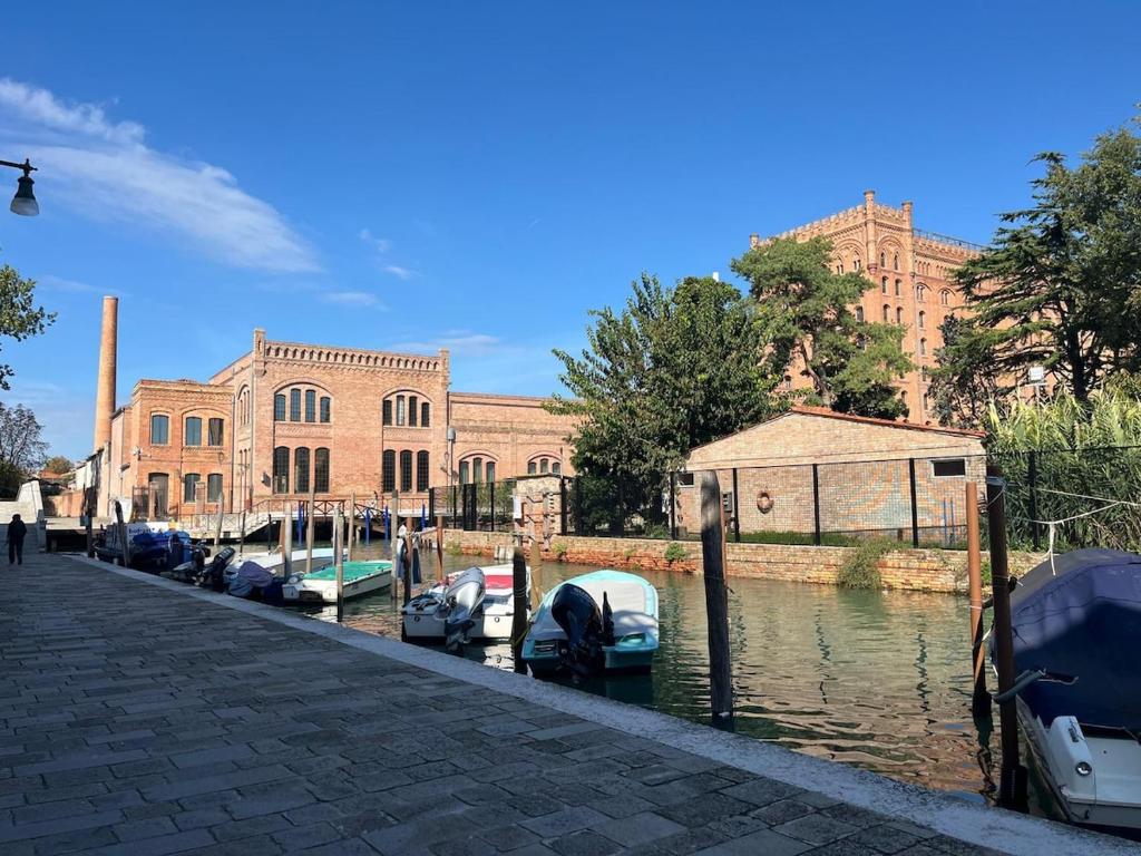 a group of boats parked in a canal in front of a building at Mia Casa in Venice