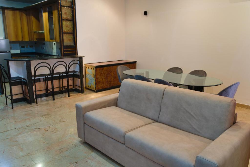 a living room with a couch and a table at Casa la torre al 14 in Rome