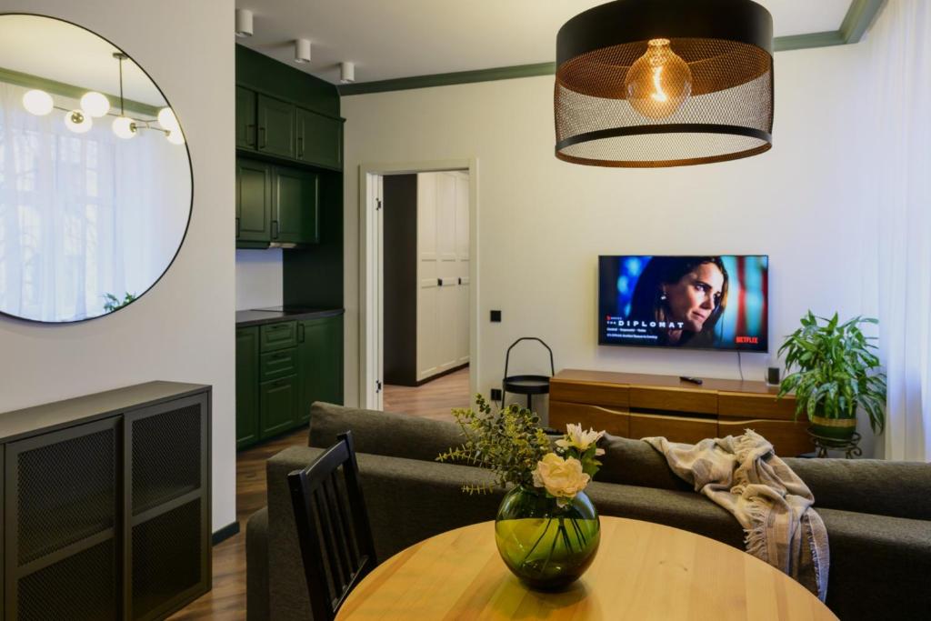 a living room with a couch and a table at Marijas Designer Apartment - Quiet Luxury in the Heart of Riga in Rīga