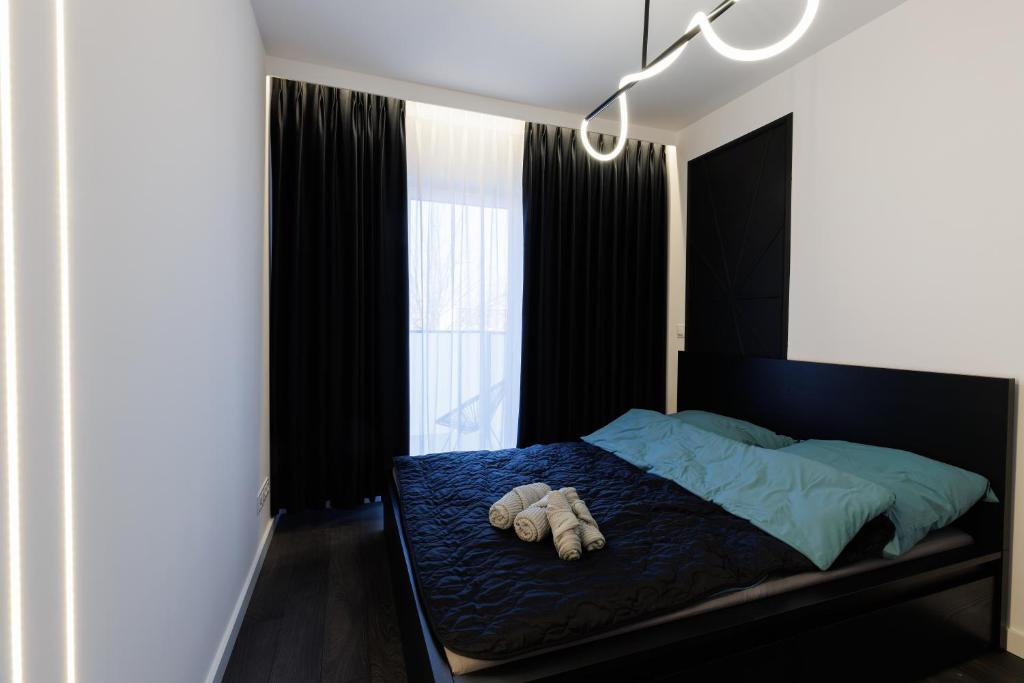 a bedroom with a bed with two pillows on it at In&cognito Apartments Głogów with Parking and WiFi in Głogów