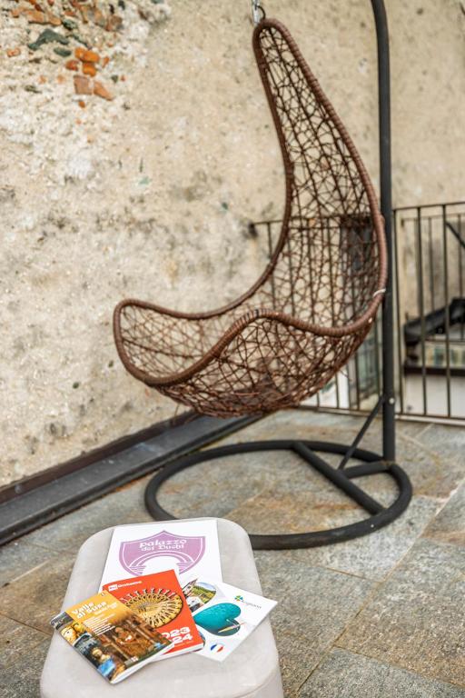 a chair sitting on top of a table with a book at Appartamento Palazzo dei Duchi in Avigliana