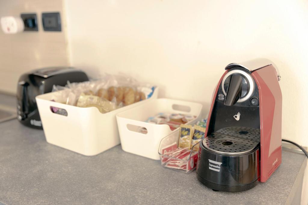 a toaster sitting on a counter next to a box of food at Appartamento Palazzo dei Duchi in Avigliana