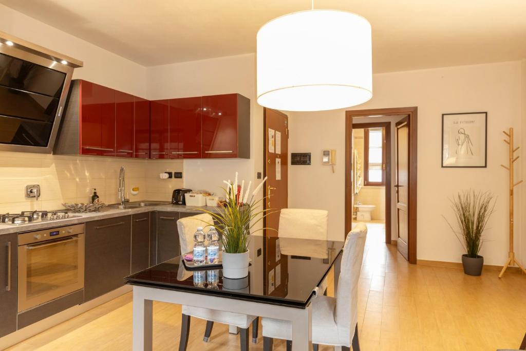 a kitchen with a table and a dining room at Appartamento Palazzo dei Duchi in Avigliana