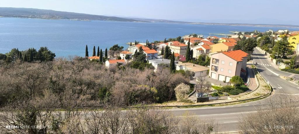 a town on a hill next to the water at Apartman Ana Mina in Crikvenica