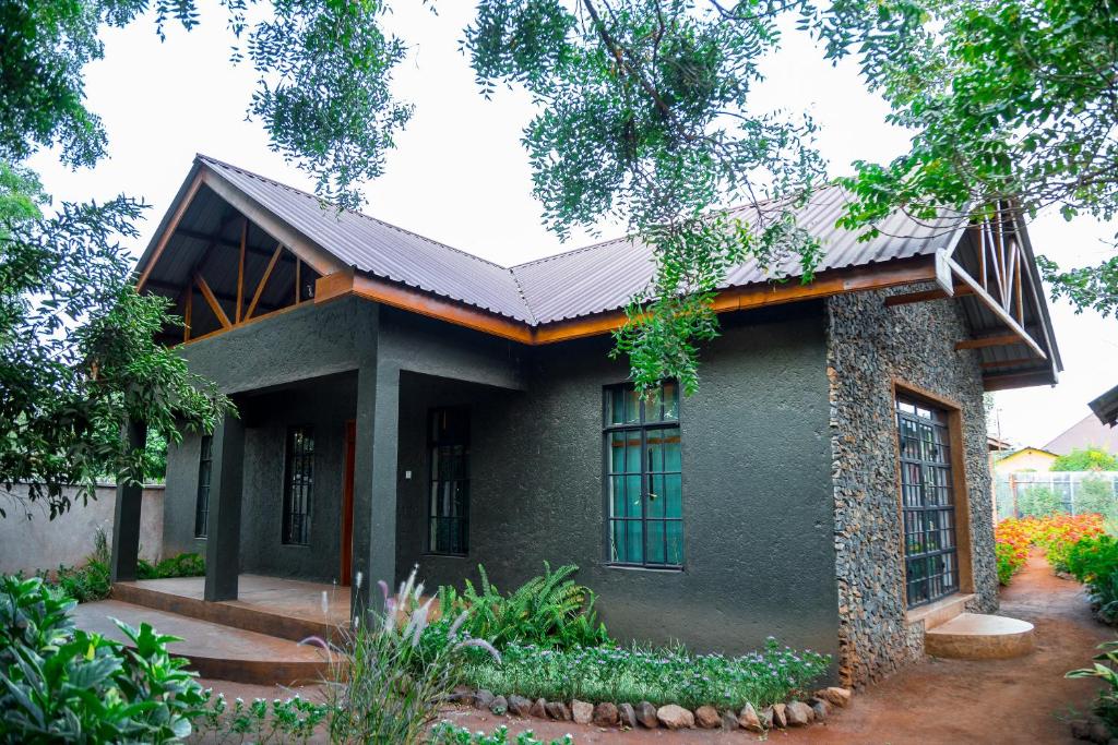 a house with a metal roof at Buffalo Villa in Boma la Ngombe