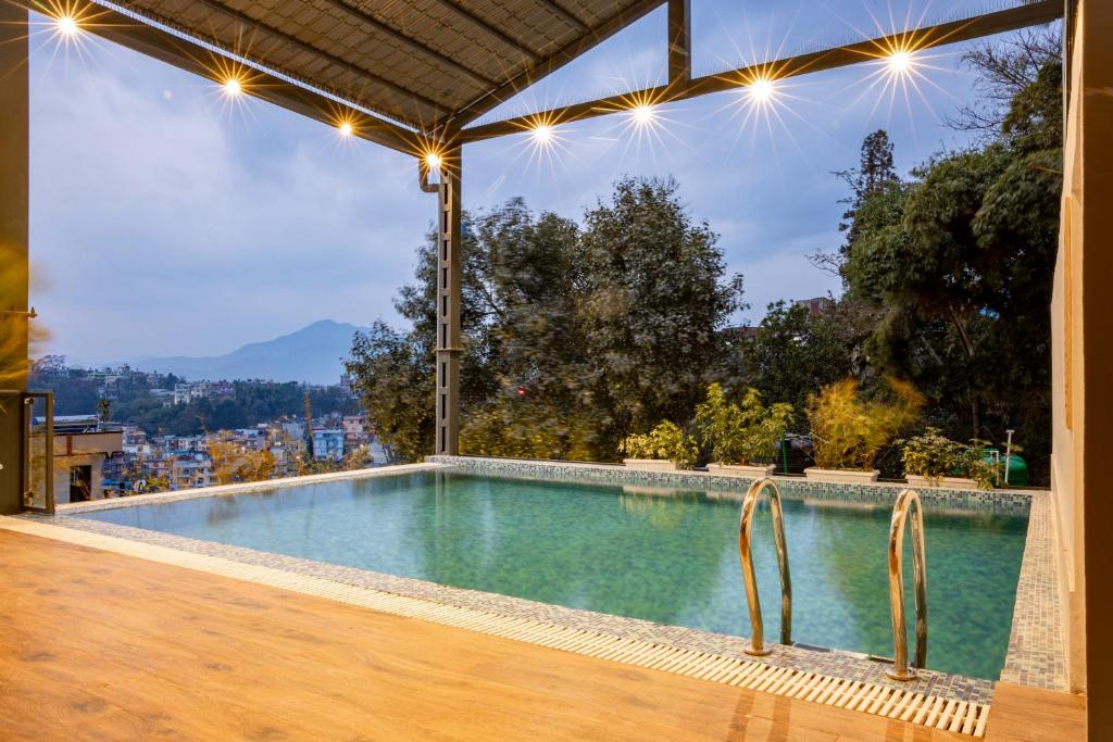 a swimming pool with a view of a city at Mhendo Hotel & Studio Suites in Kathmandu