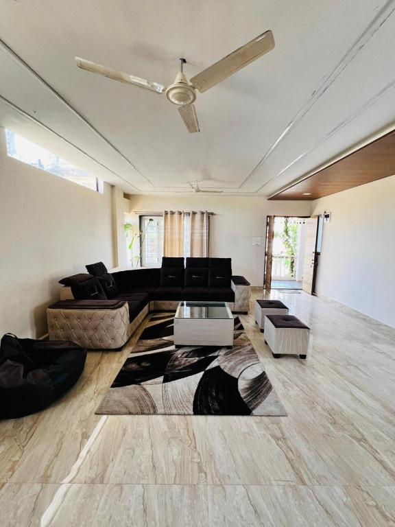 a living room with a couch and a table at CozyNest Retreat in Belgaum