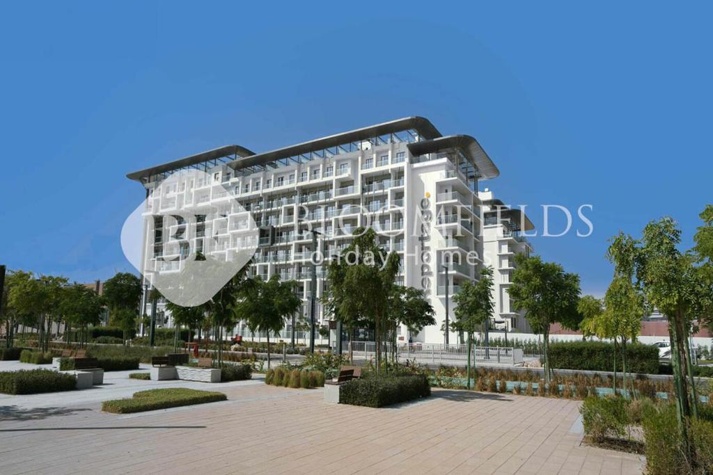 a rendering of a large white building at Bloomfields Pretty Stu in Oasis in Abu Dhabi Intl