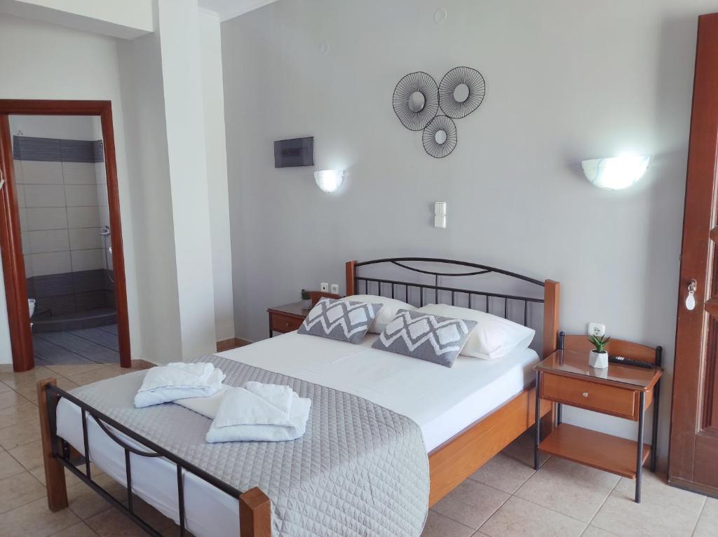 a bedroom with a bed with two towels on it at Vythos in Adamas