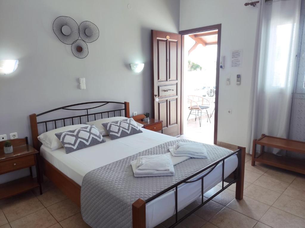 a bedroom with a bed with two towels on it at Vythos in Adamas