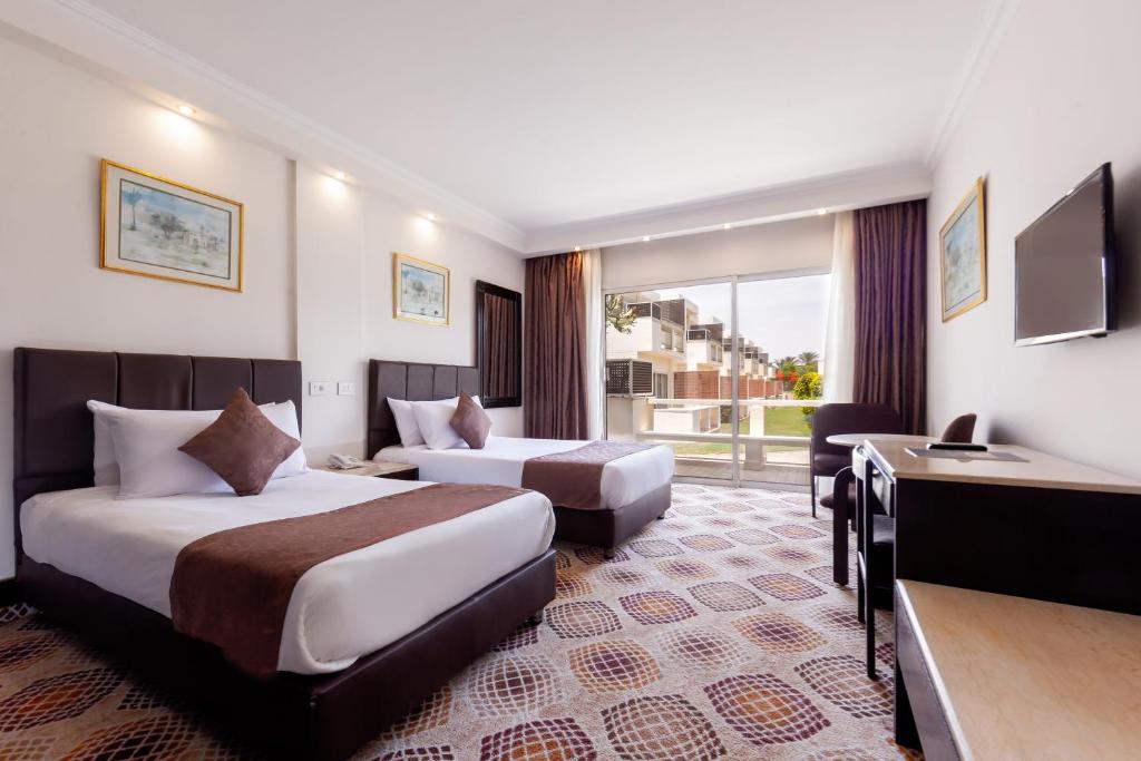 Cama o camas de una habitación en Pyramids Park Resort Cairo