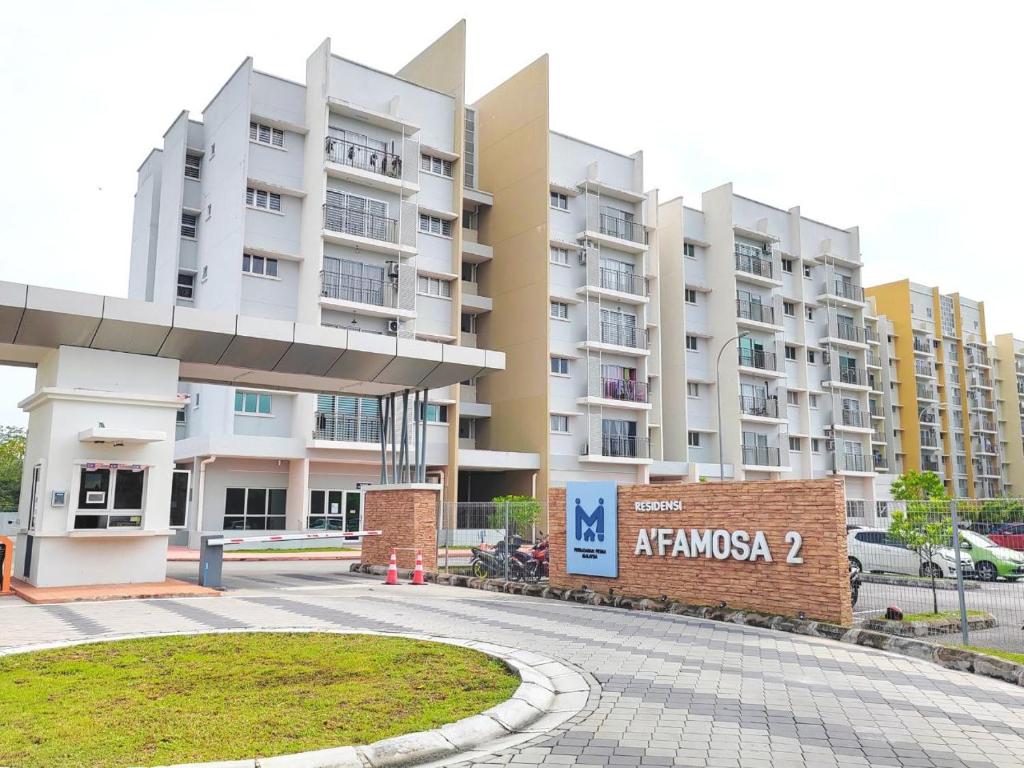 a large apartment building with a sign in front of it at GRANDE MAISON 3 NEAR AFAMOSA WaterPark in Kampong Pulau Sebang
