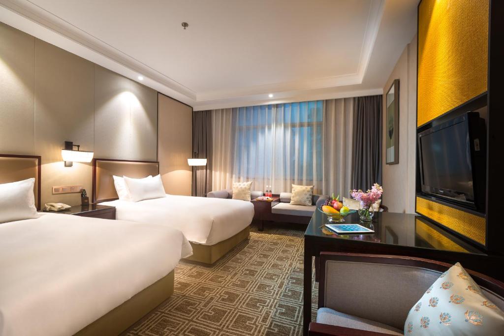 Postel nebo postele na pokoji v ubytování Yiwu Kasion Purey Hotel