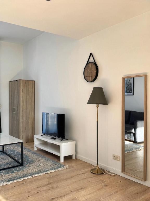 a living room with a tv and a mirror at Loft Luna Brussels Midi in Brussels