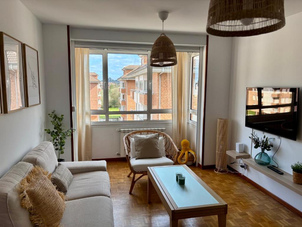 a living room with a couch and a table at La Piragua in Ribadesella