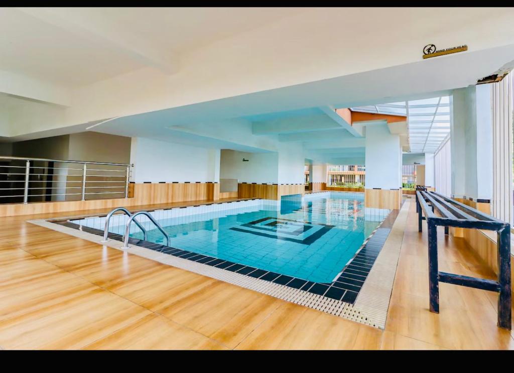 a large swimming pool in a large room at Urban Oasis 2BR in Nairobi