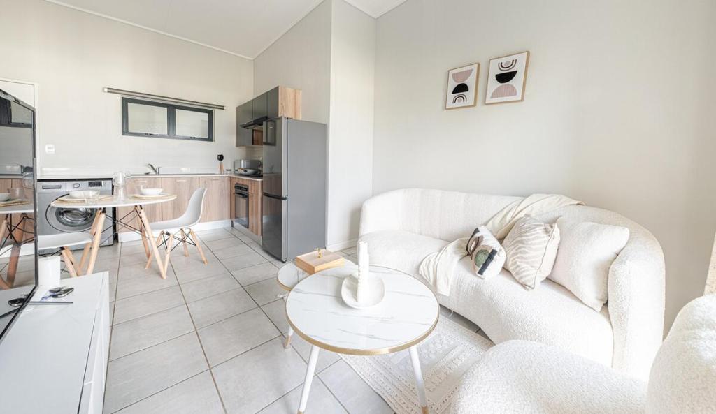 a living room with a white couch and a table at Exquisite Lavish-Luxury Apartment in Sandton