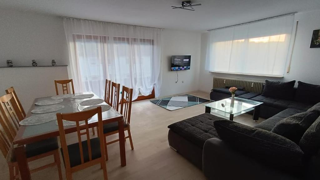 a living room with a table and a couch at Apartment Linda in Tuttlingen