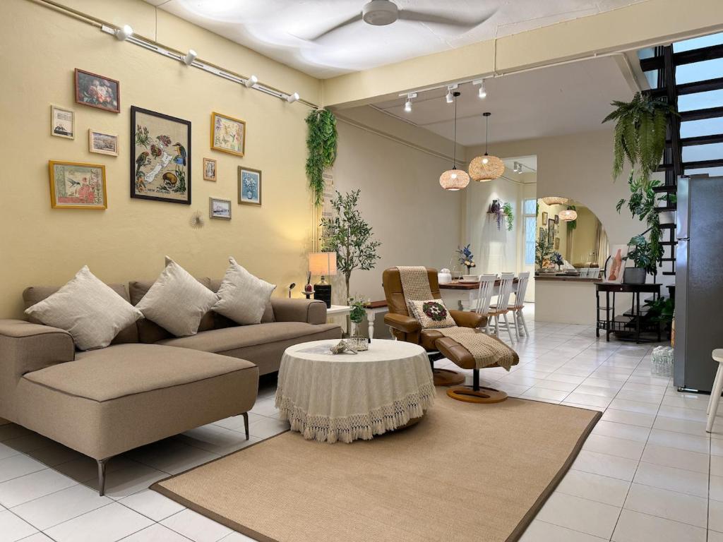 a living room with a couch and a table at 3 Bedroom NORDIC HOME Full Kitchen 8 MINS to MRT & JODD Fair & near RCA in Bangkok