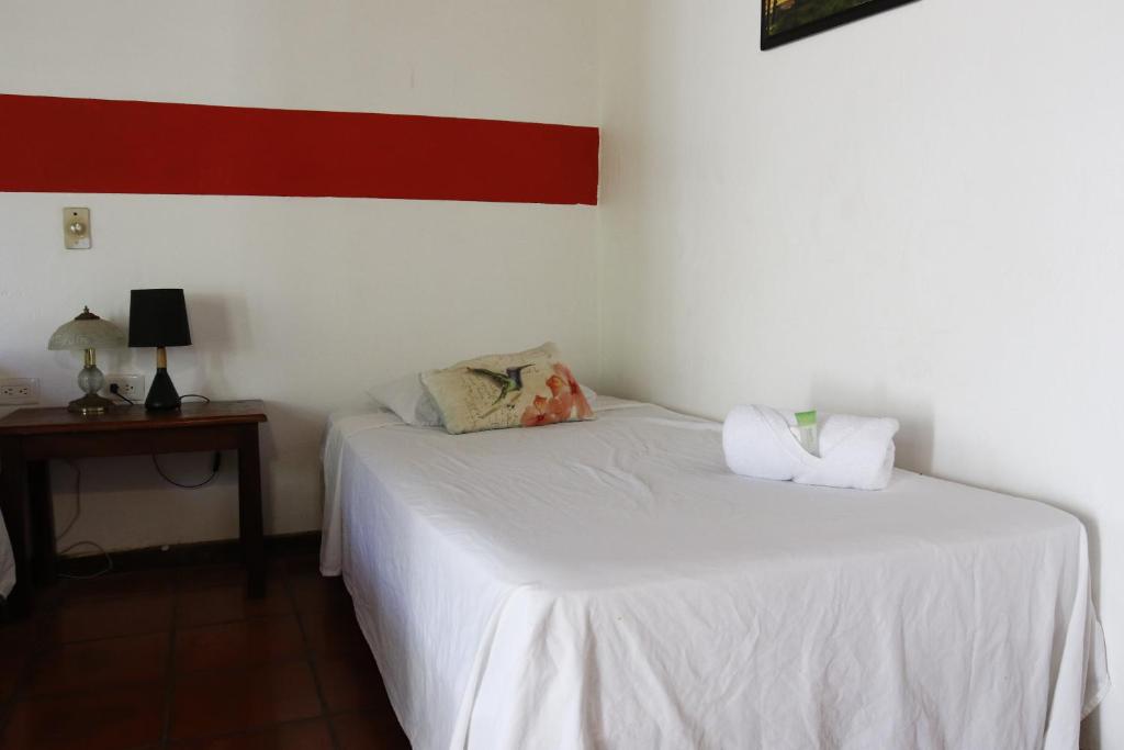 Postel nebo postele na pokoji v ubytování Hotel Hibiscus