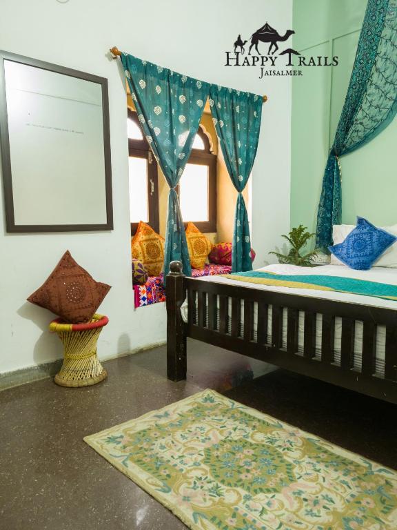 a room with a bench and a picture on the wall at Happy Trails Jaisalmer in Jaisalmer
