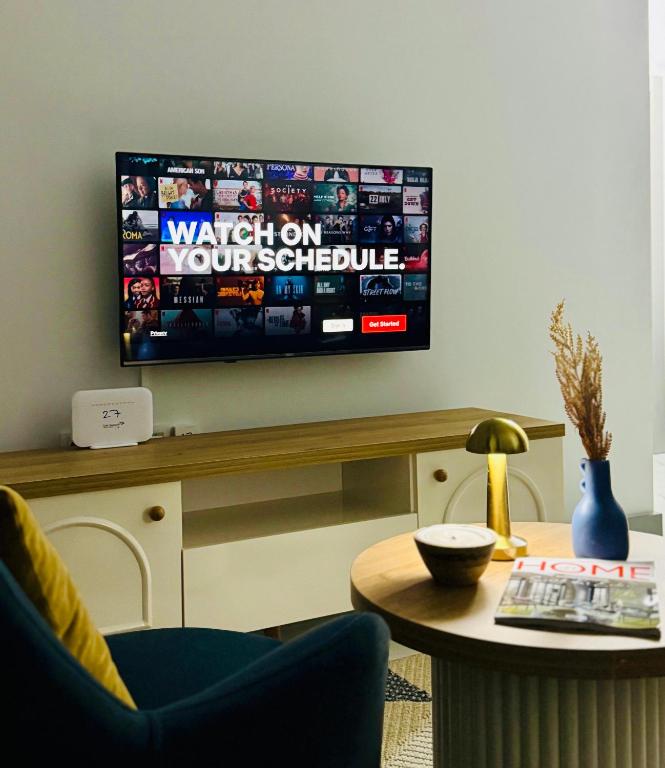 a living room with a television on a wall at Sunny Shores Holiday in Alanya