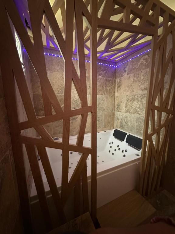 a bath tub in a room with a wooden ceiling at Gîte Sainte Baume in Plan dʼAups