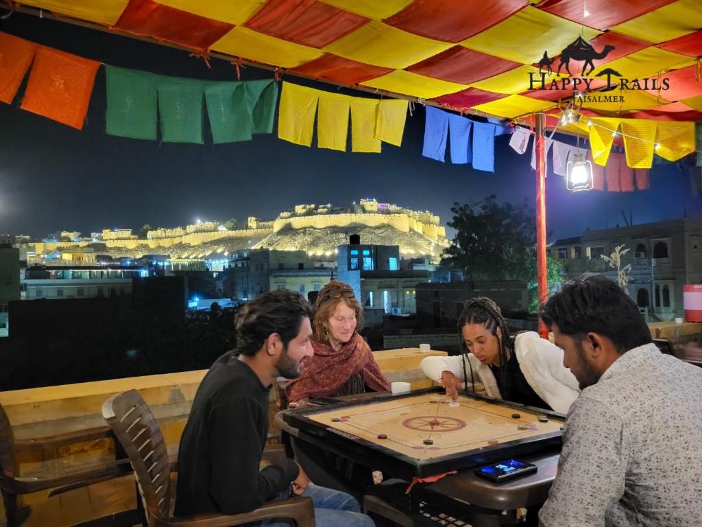 a group of people sitting around a table playing a game at Happy Trails Jaisalmer in Jaisalmer